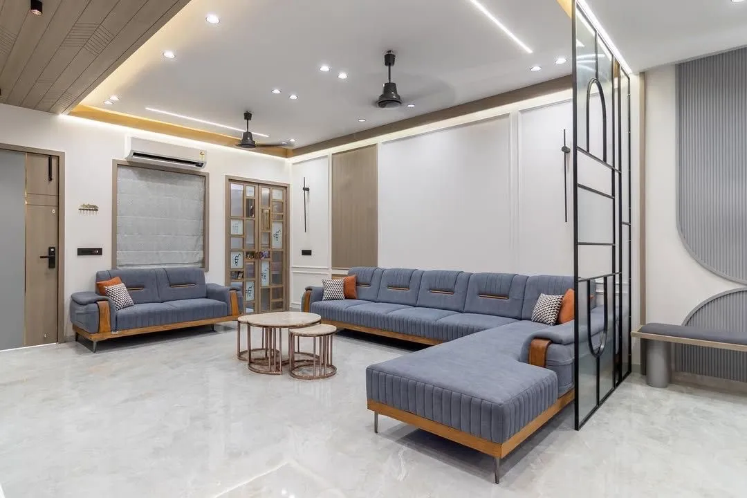Living room featuring a blue-grey sectional and an arched metal divider