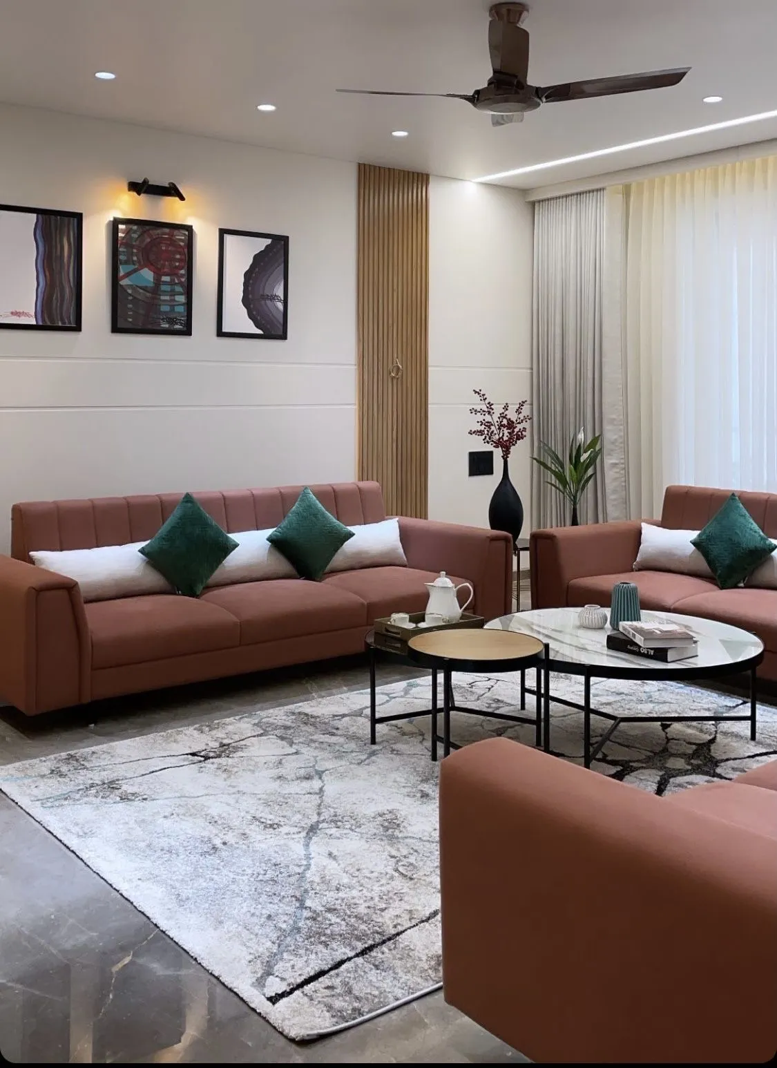 Opulent living room with rust velvet sofas and a marble nesting table