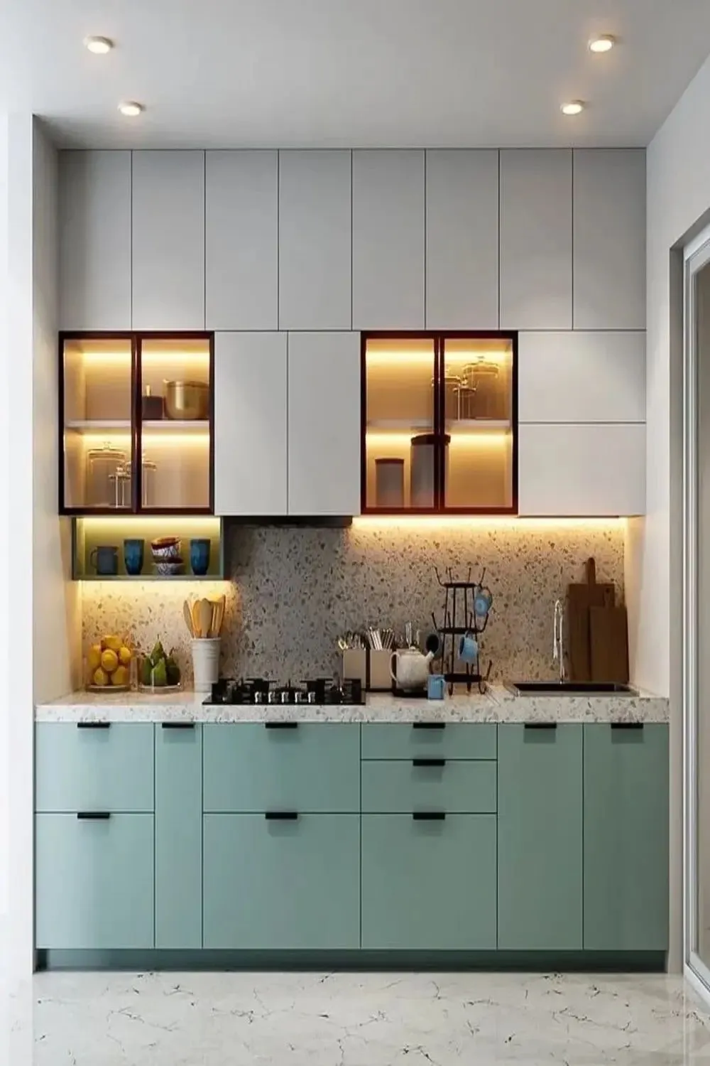 Modern kitchen featuring sage green cabinets and terrazzo details